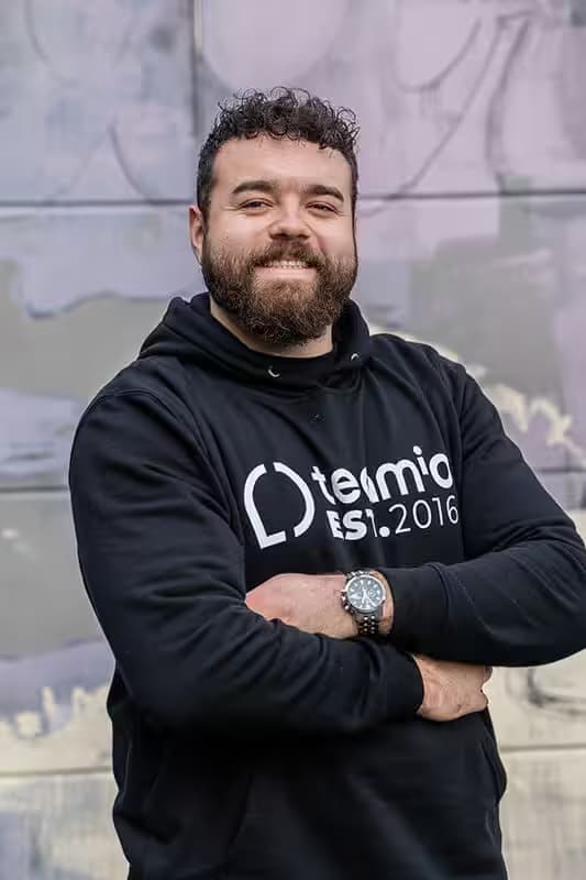 Man with a beard wearing a “termio” hoodie