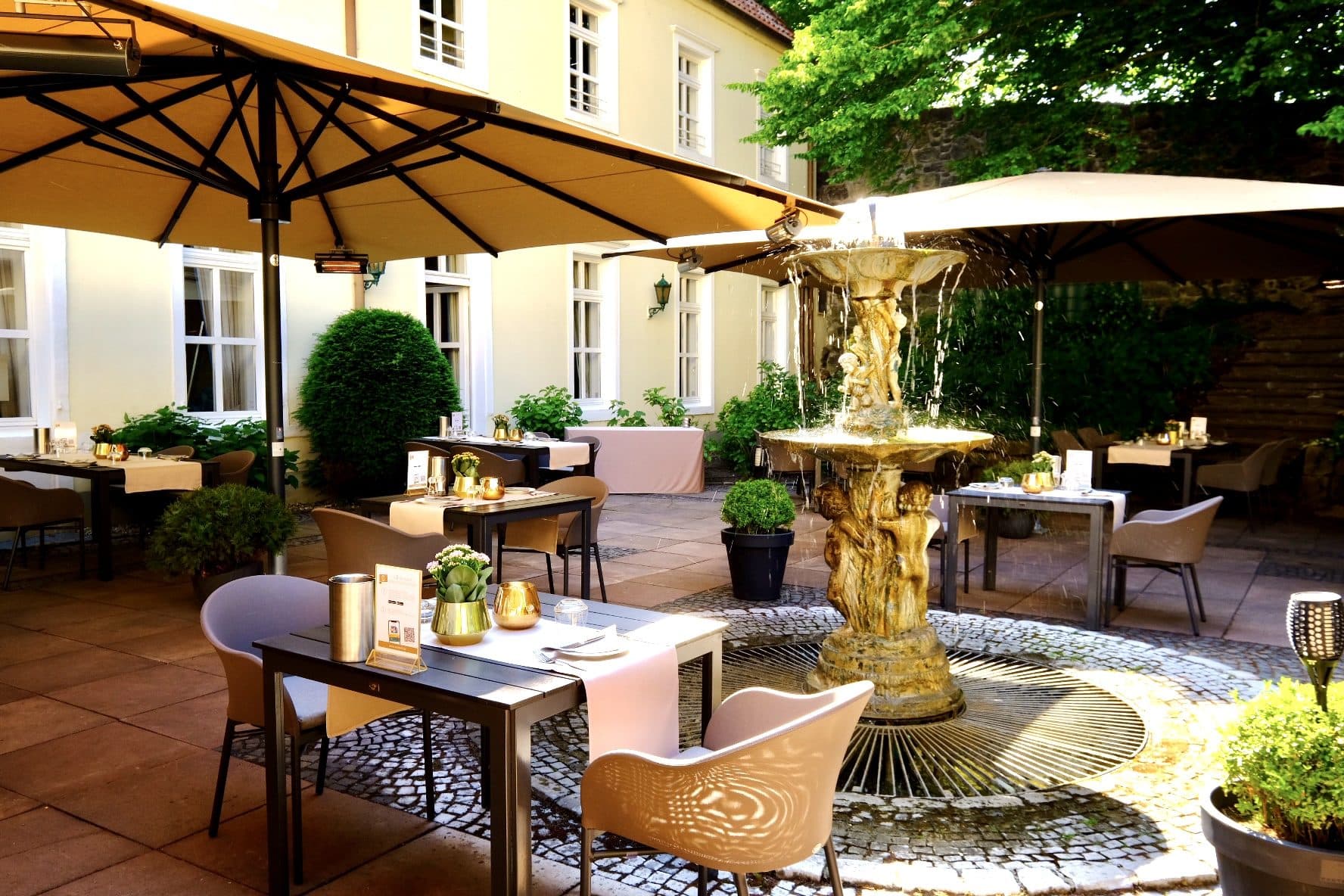 Courtyard terrace at the Parkhotel Engelsburg with a fountain and seating