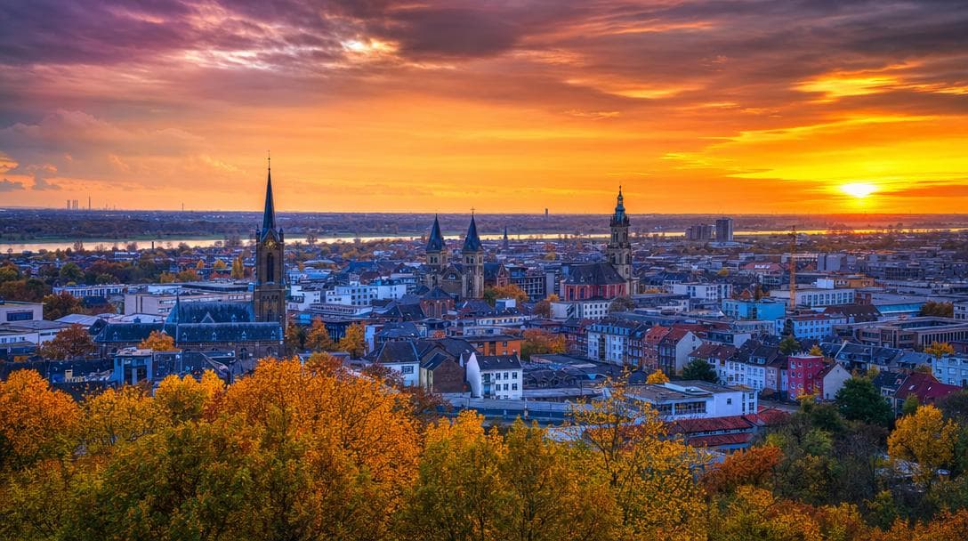 City panorama with church towers at sunset
