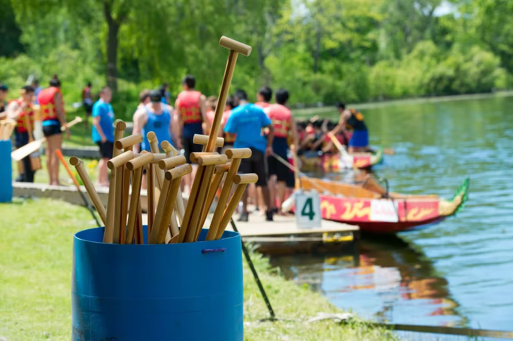 Paddles ready on the bank as the team boards the dragon boat