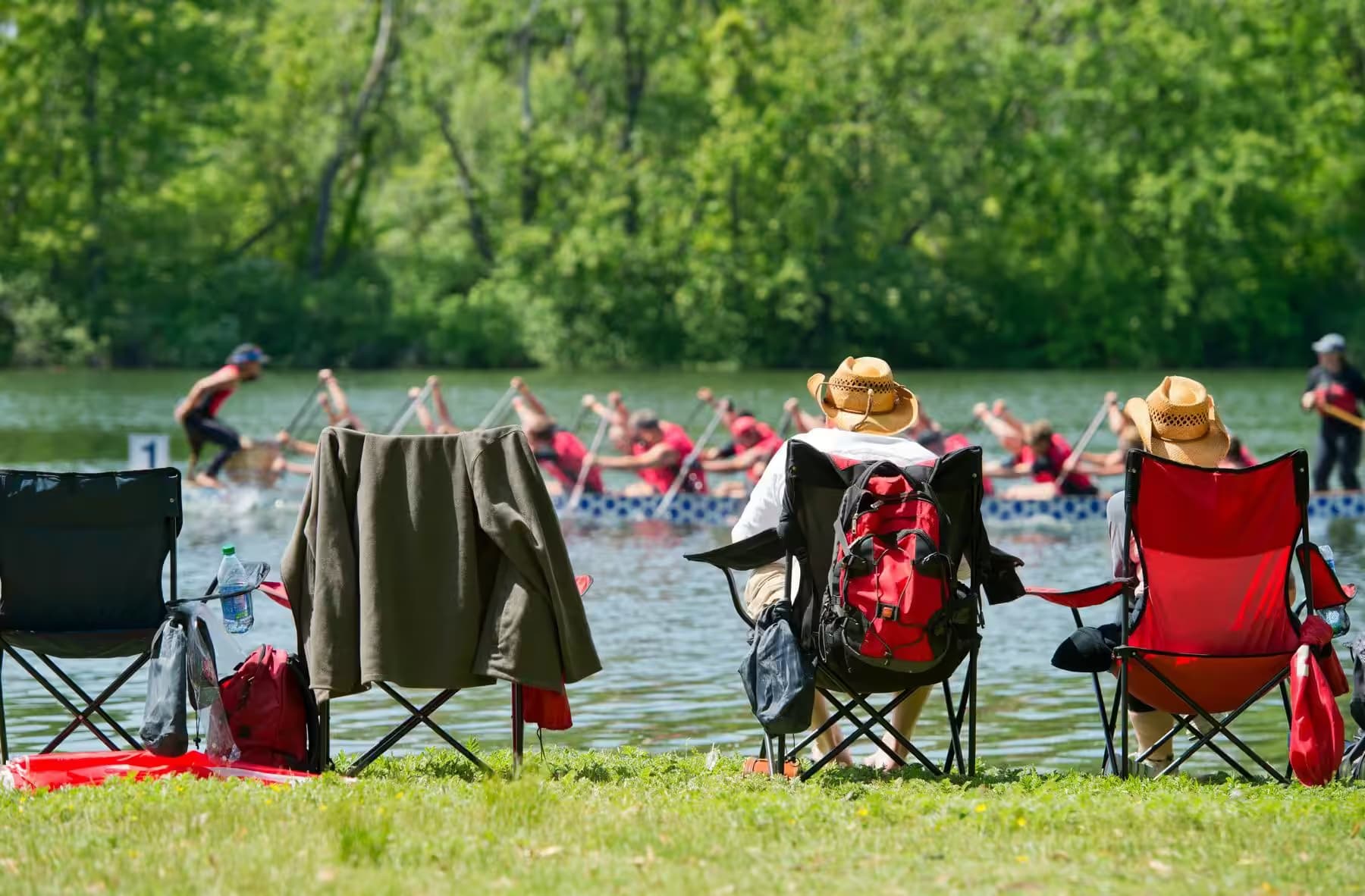 Spectators watching a dragon boat race from the bank