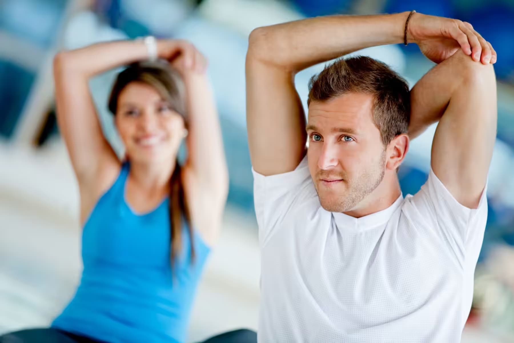 Group shoulder and arm stretches at a fitness team event