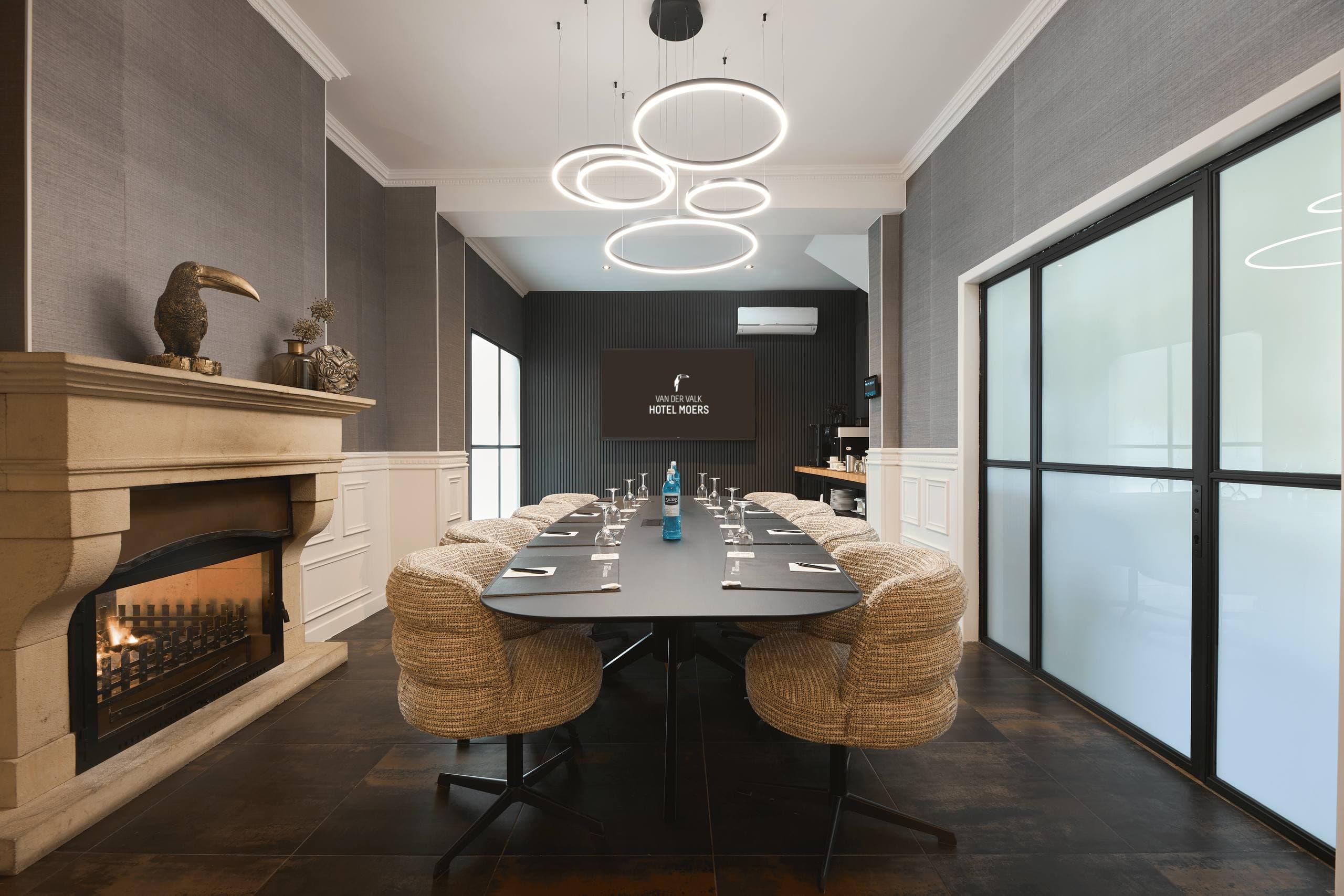 Meeting room with long conference table and fireplace at the Van der Valk Hotel Moers