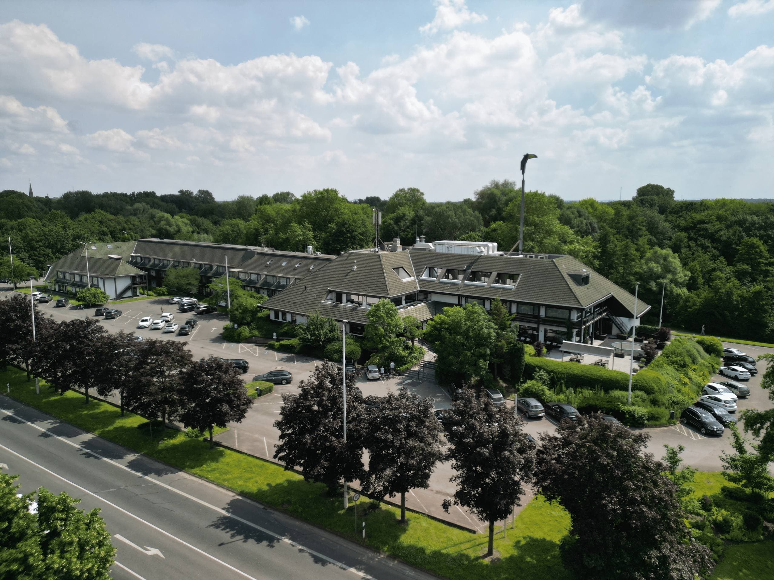 Aerial view of the Van der Valk Hotel Moers with car park and surrounding greenery