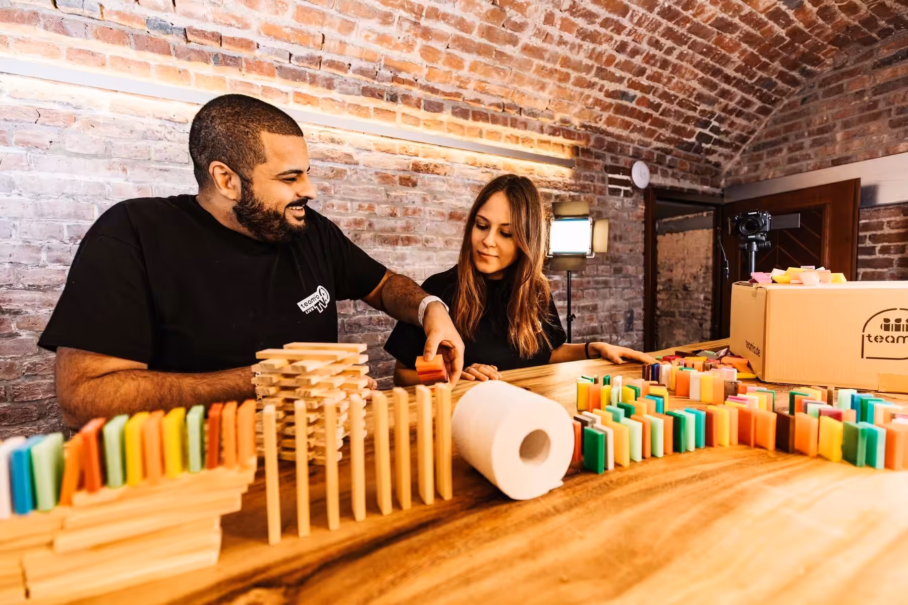 Online domino chain reaction event for company teams